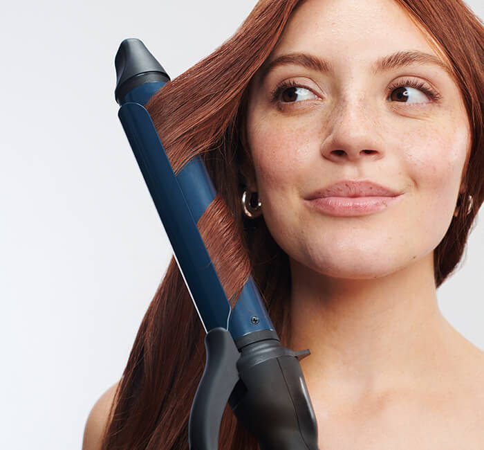Model with Graphene MX® Long Barrel Curling Iron 1.25”